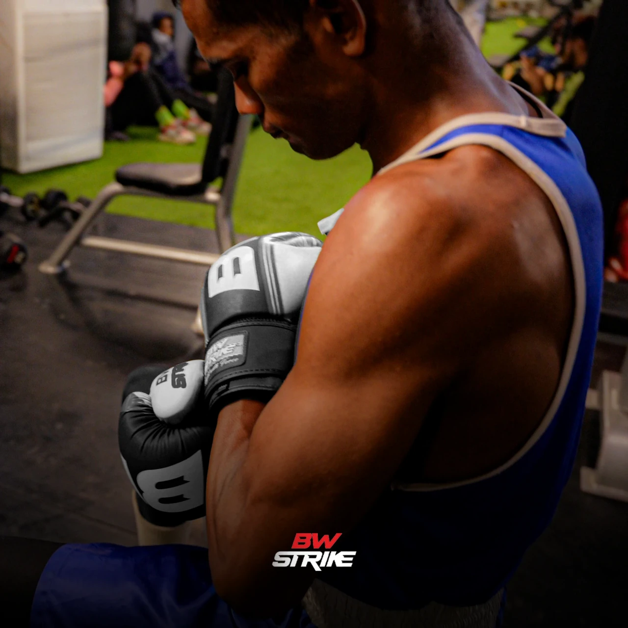 BW Strike product photography — Black glove in a gym portrait