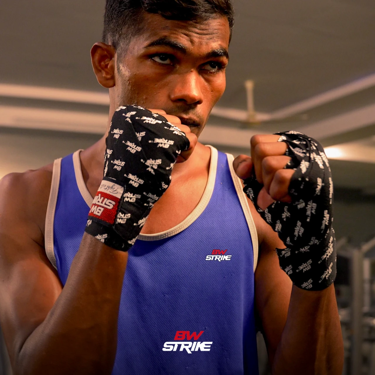 BW Strike product photography — Boxer portrait with fingerless training gloves